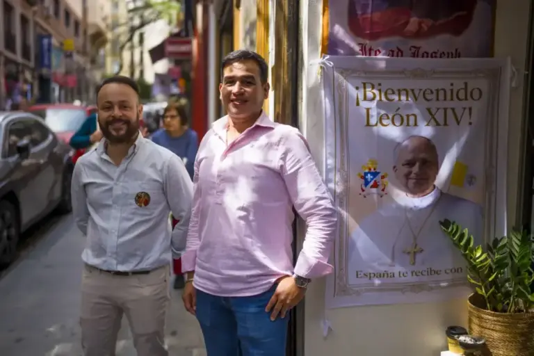 Pedro and Christian in front of Salve, the shop that made the Pope's clothes.