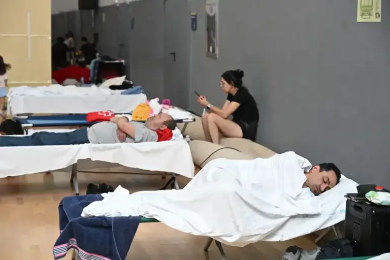 Residents of the evacuated towns in a sports center in Las Rozas.