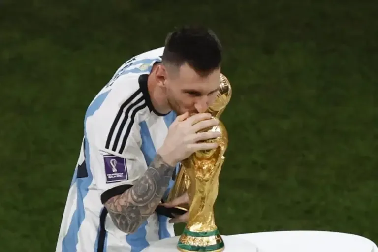 Lionel Messi of Argentina kisses the Qatar 2022 FIFA World Cup trophy