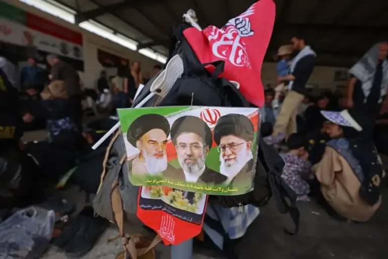 A man holds a sign in honor of Khomeini, Ali Khamenei and Mojtaba Khamenei, in Tehran.