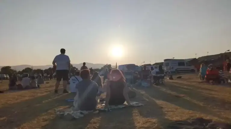 Living a historic eclipse: the shame of the Sun, a rosary, and shouts of "out out out!"