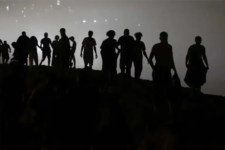 Dozens of migrants walk towards Castillejos, north of Morocco, after leaving Ceuta on August 1.