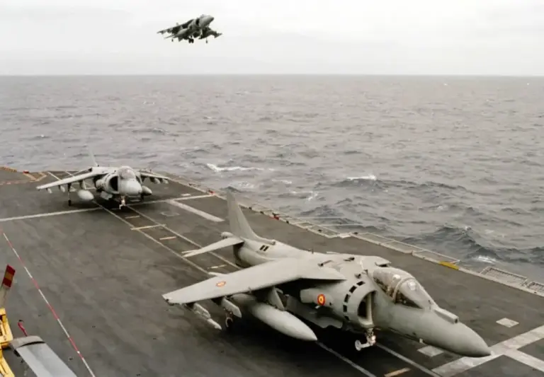 Spanish Harriers take off from an aircraft carrier deck.