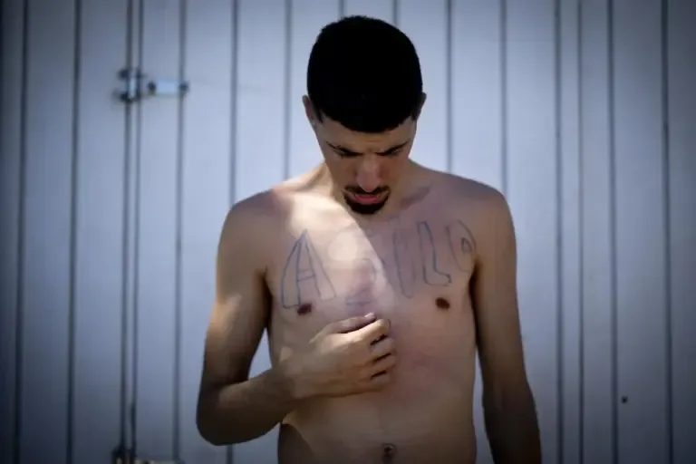 The Algerian Mohammed, with the word 'asylum' painted on his chest.