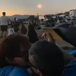 Living a historic eclipse: the shame of the Sun, a rosary, and shouts of "out out out!"