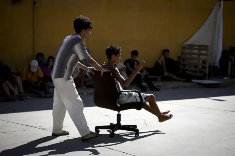 Two teenagers play with an office chair in this 'favela' in Ceuta.