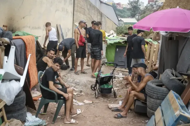 The oldest in the settlement gather away from the minors.