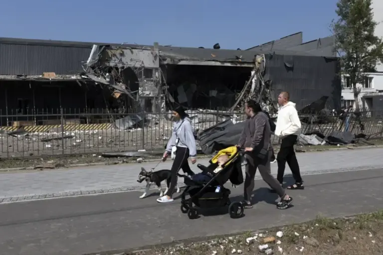 Some residents pass by a Nova Poshta company center, attacked with Russian ballistic missiles in Kyiv.