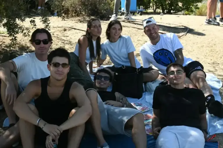 A group of young Italians watching the race with an improvised picnic.
