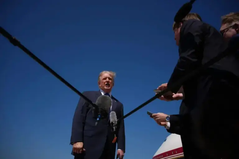 Donald Trump talks with journalists before boarding Air Force One.
